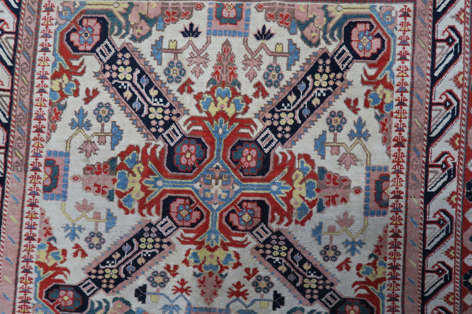 Detailed shot highlighting the intricate patterns and vibrant color palette of the rug