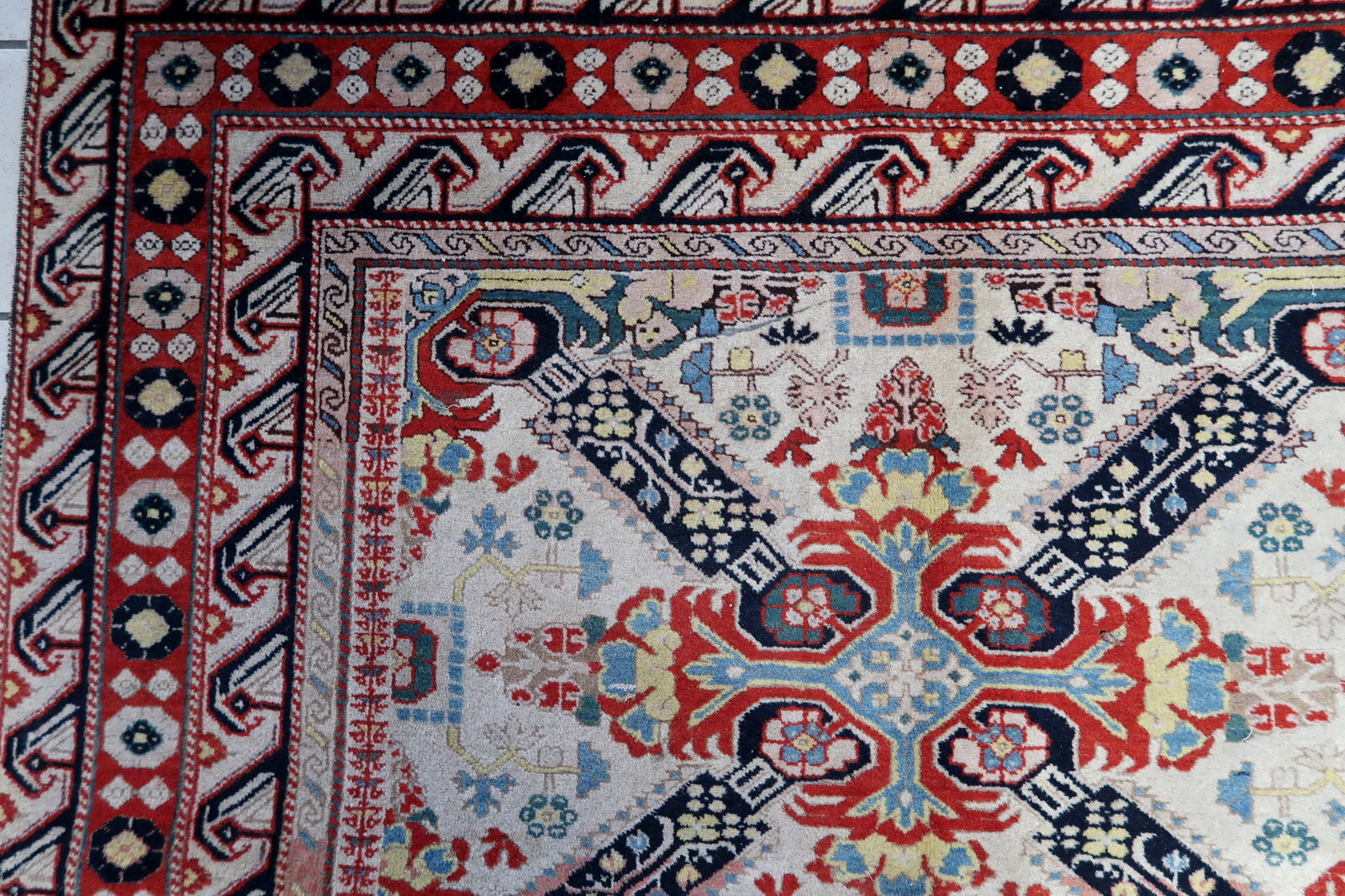 Detailed shot showcasing the texture and weave of the handmade vintage Caucasian Zeyhur rug