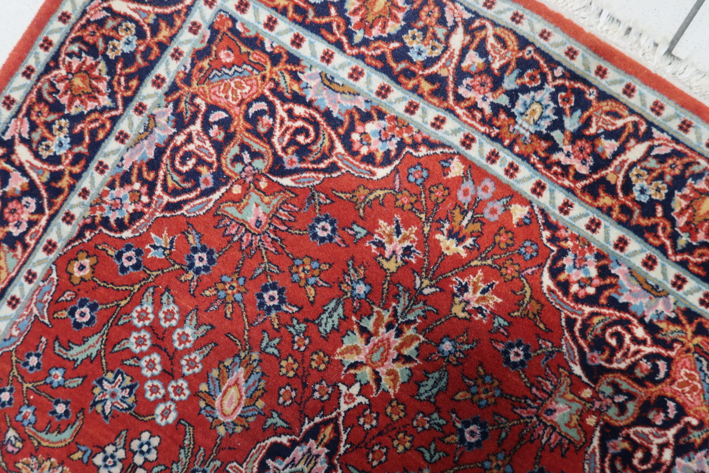 Detailed view of the shiny appearance and luxurious texture of the rug's wool material.