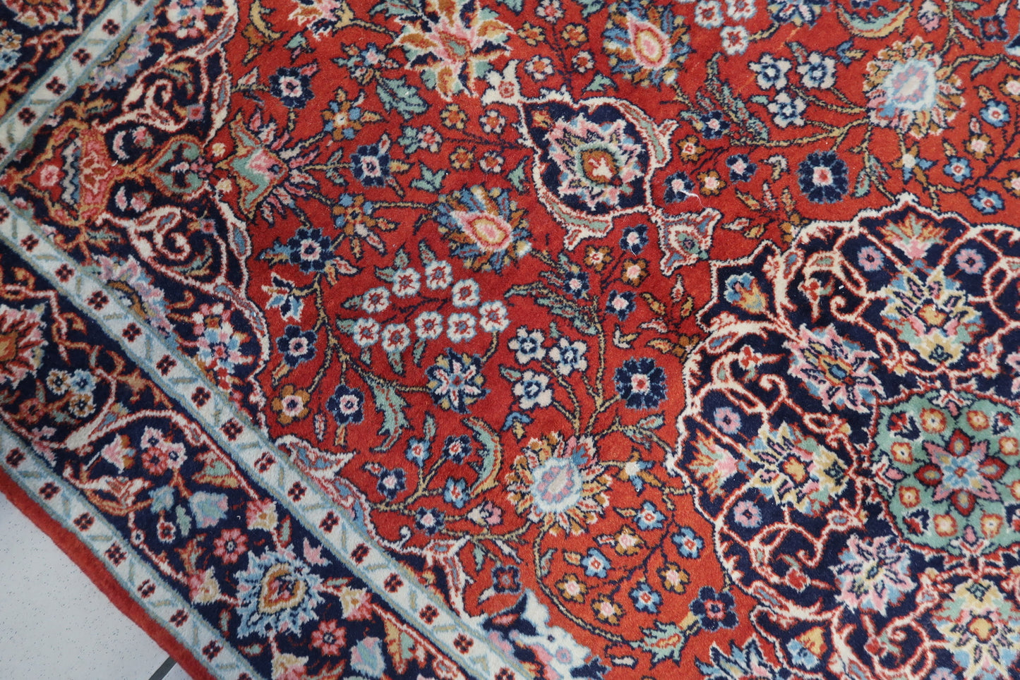 Detailed picture capturing the vintage charm and timeless beauty of the Persian Kashan rug.