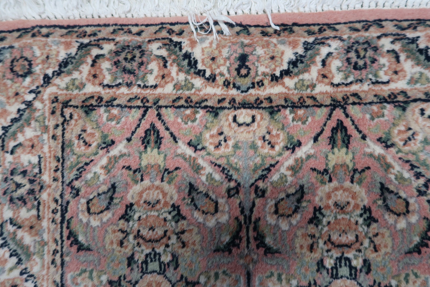 Detailed view of the soft texture and wool material used in the rug's construction.