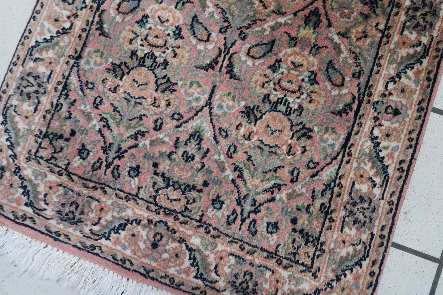 Close-up view showcasing the artistic brown designs and fine craftsmanship on the rug.