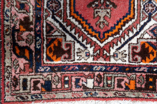 Close-up of the intricate geometric medallion on the handmade vintage Persian Hamadan rug