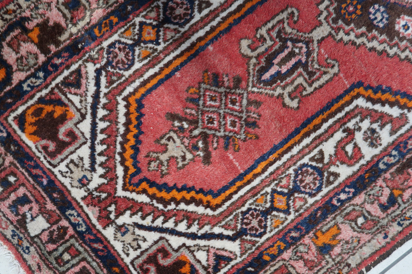 Close-up showcasing the vibrant red background and traditional design of the Persian Hamadan rug