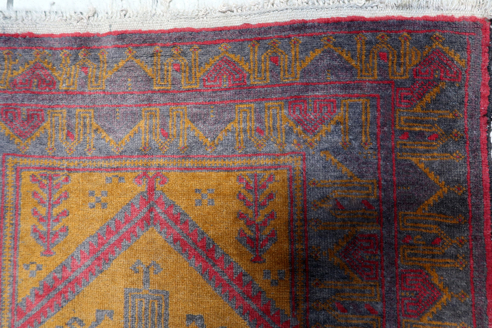 Intricate geometric patterns and tribal influences on the Afghan Baluch rug