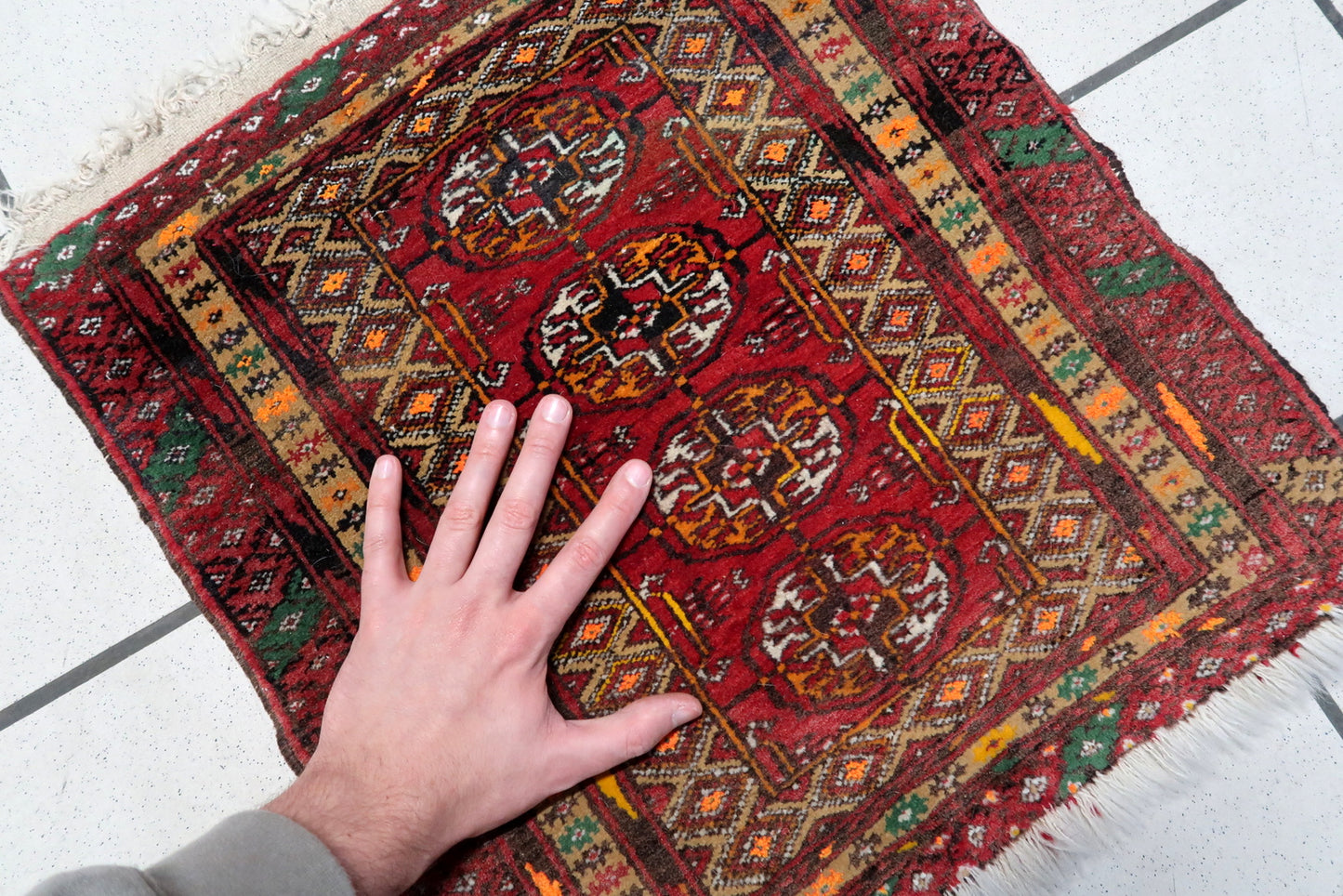 Close-up of the white and orange accents on the Afghan Ersari mat