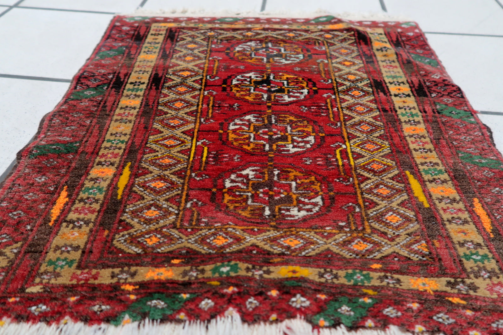 Detailed view of the compact size and texture of the vintage Afghan Ersari mat
