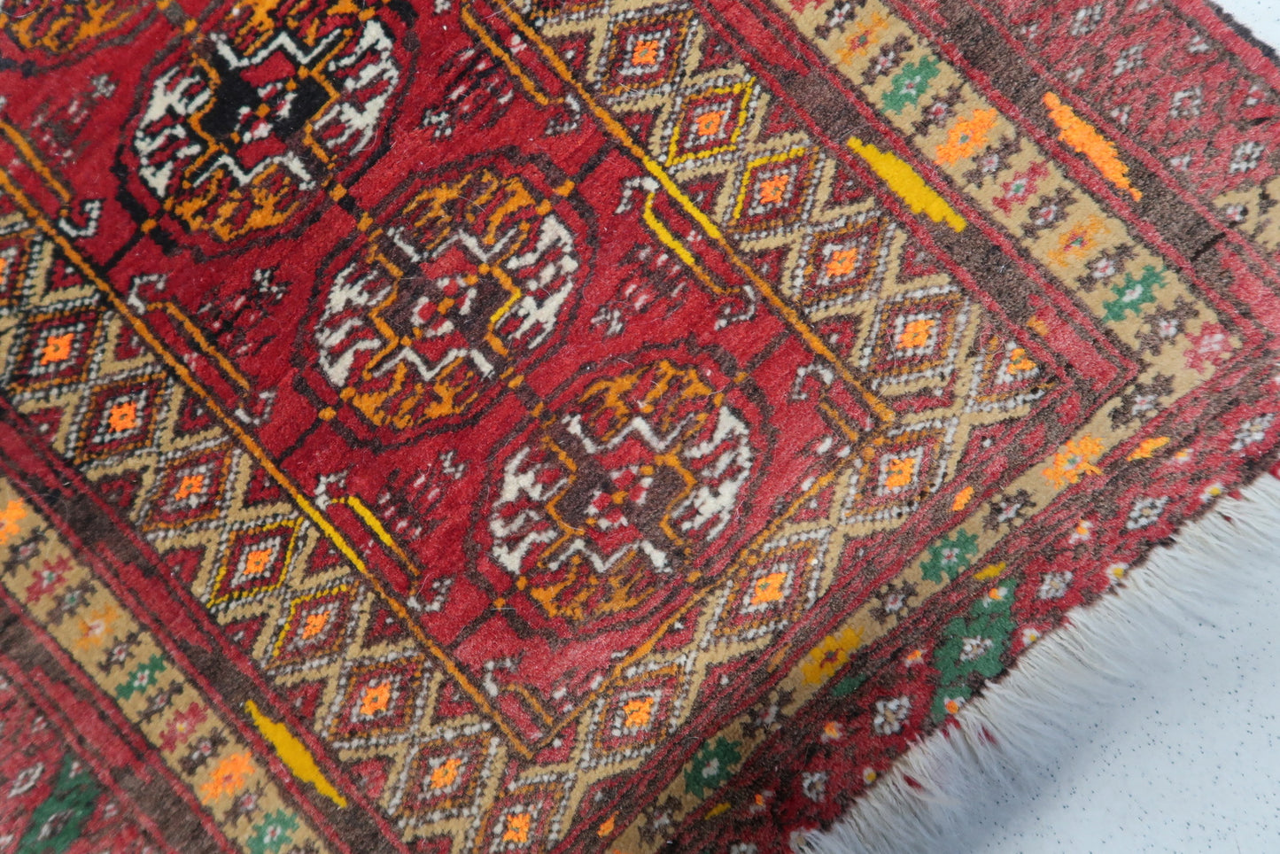 Close-up of the yellow and green colors on the Afghan Ersari mat
