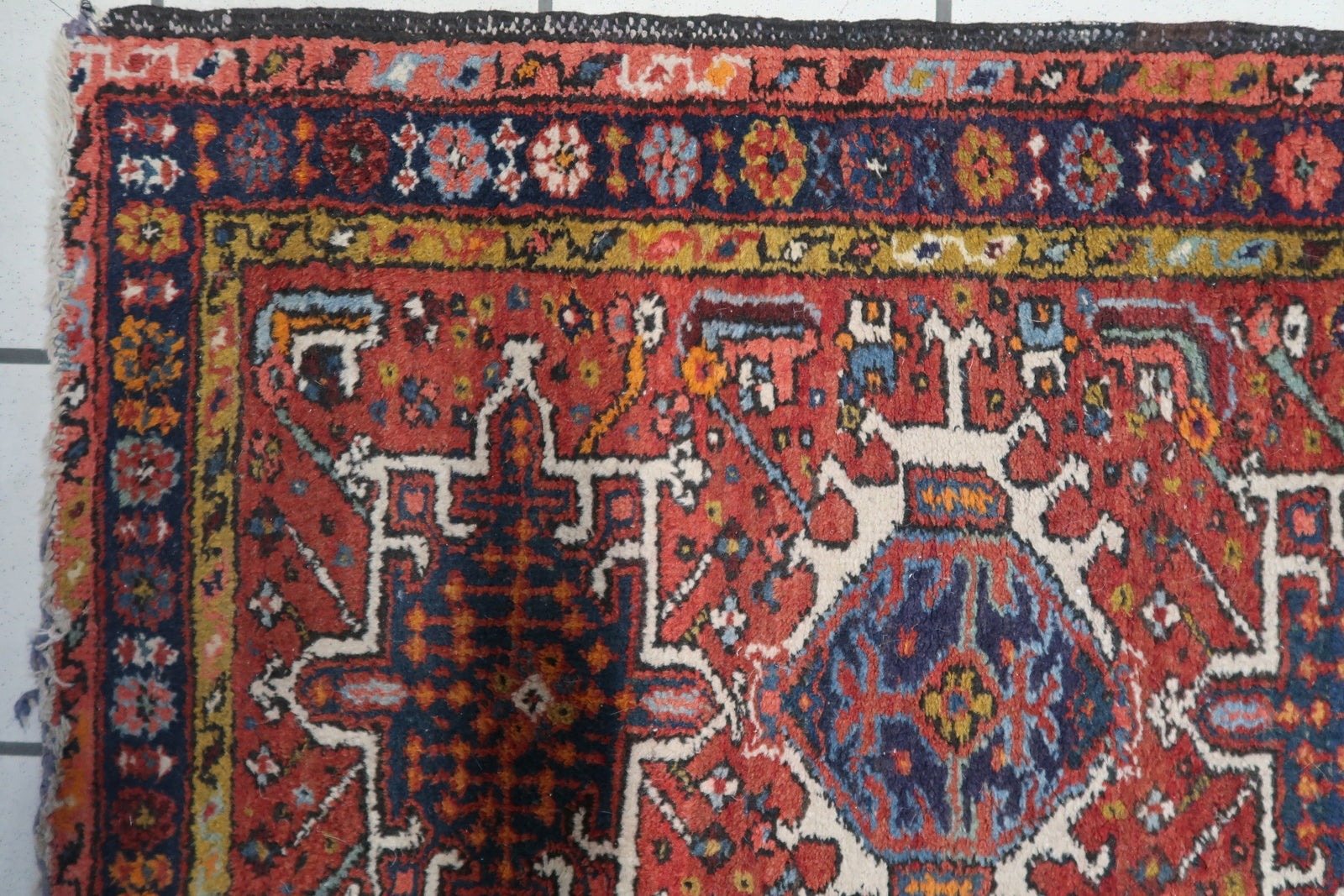 Detailed view of the turquoise and yellow accents on the Handmade Antique Persian Karajeh Rug