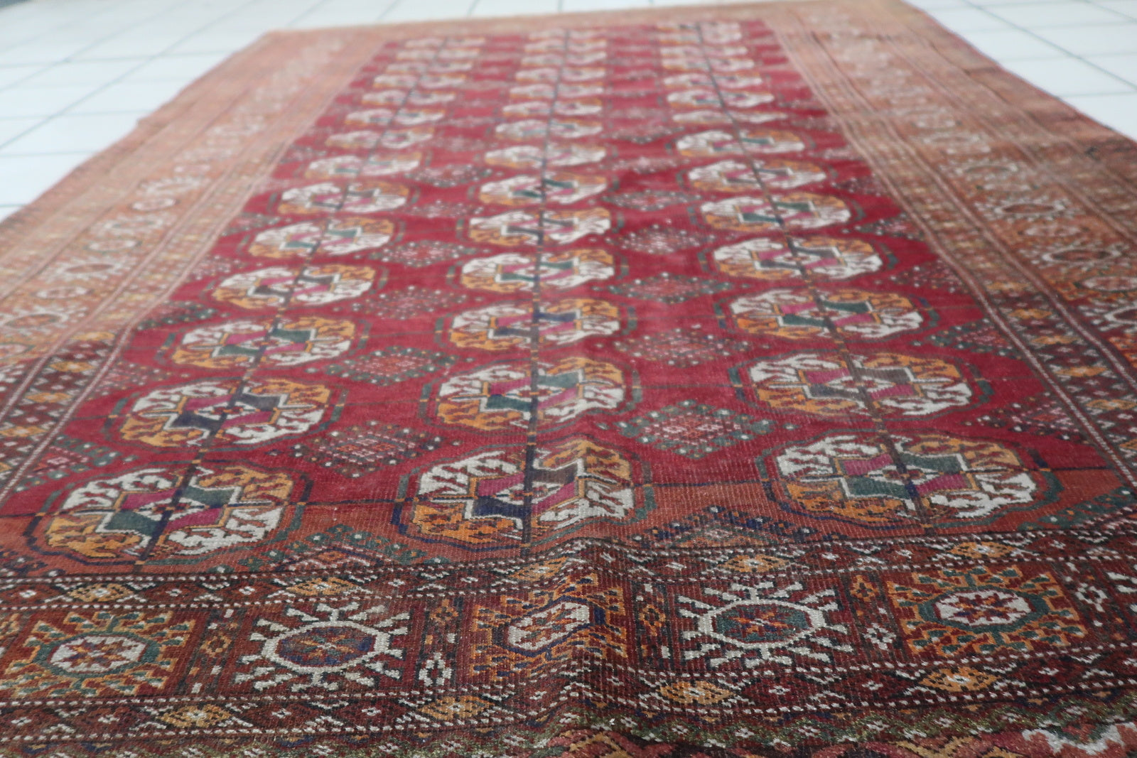 Detailed view of the orange geometric borders on the Handmade Vintage Uzbek Bukhara Rug