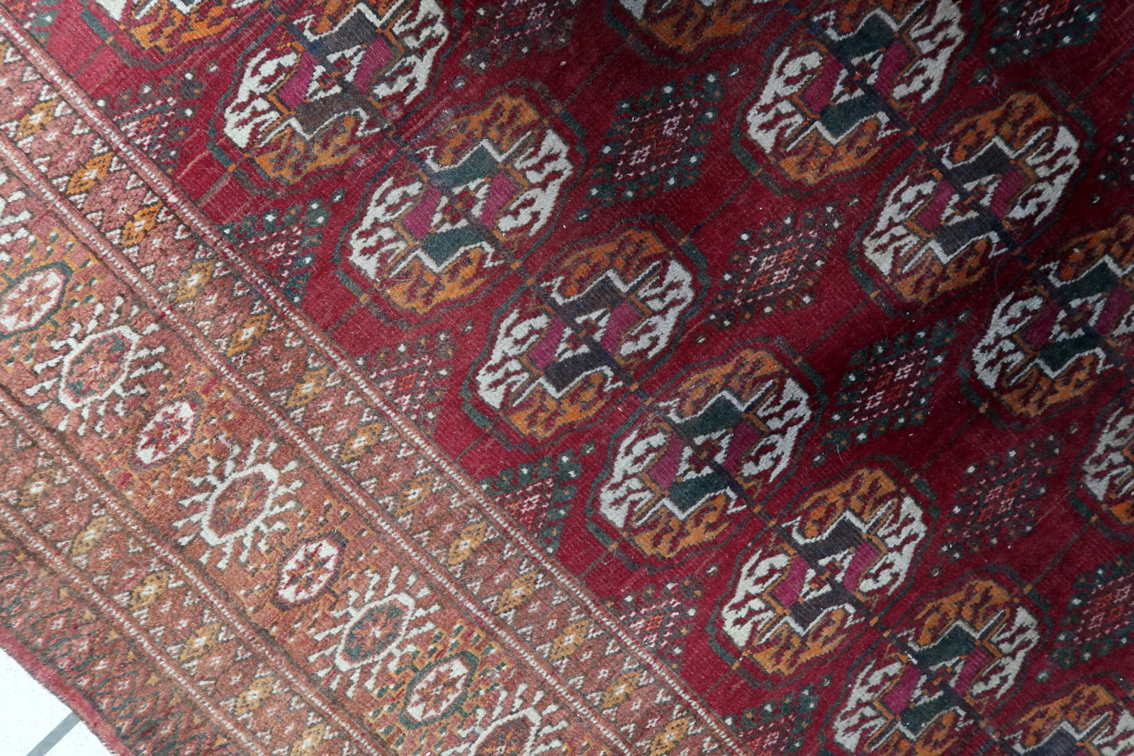 Detailed view of the low pile condition on the Handmade Vintage Uzbek Bukhara Rug