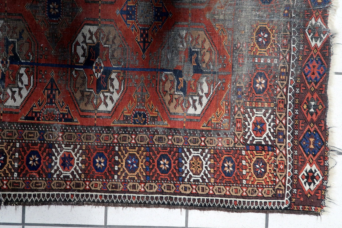 Close-up of Intricate Patterns on Vintage Afghan Baluch Rug