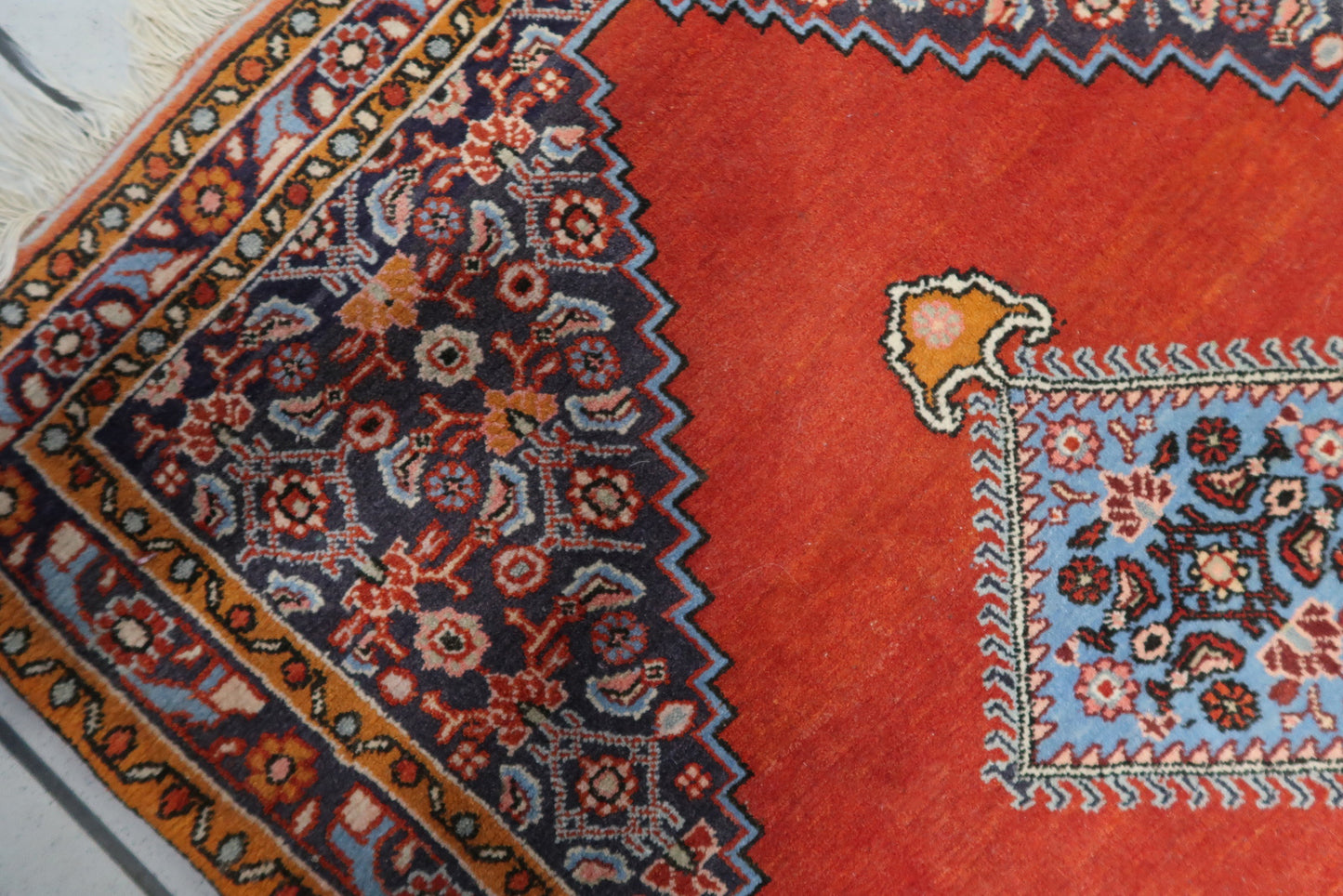 Gold and dark orange accents within the geometric design

