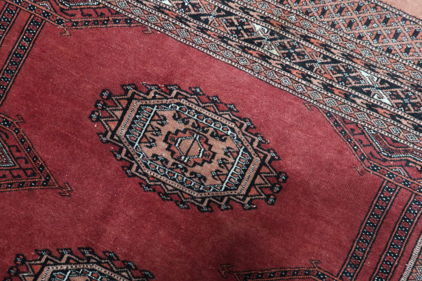Detailed View of Rug's Ruby Red Patterns