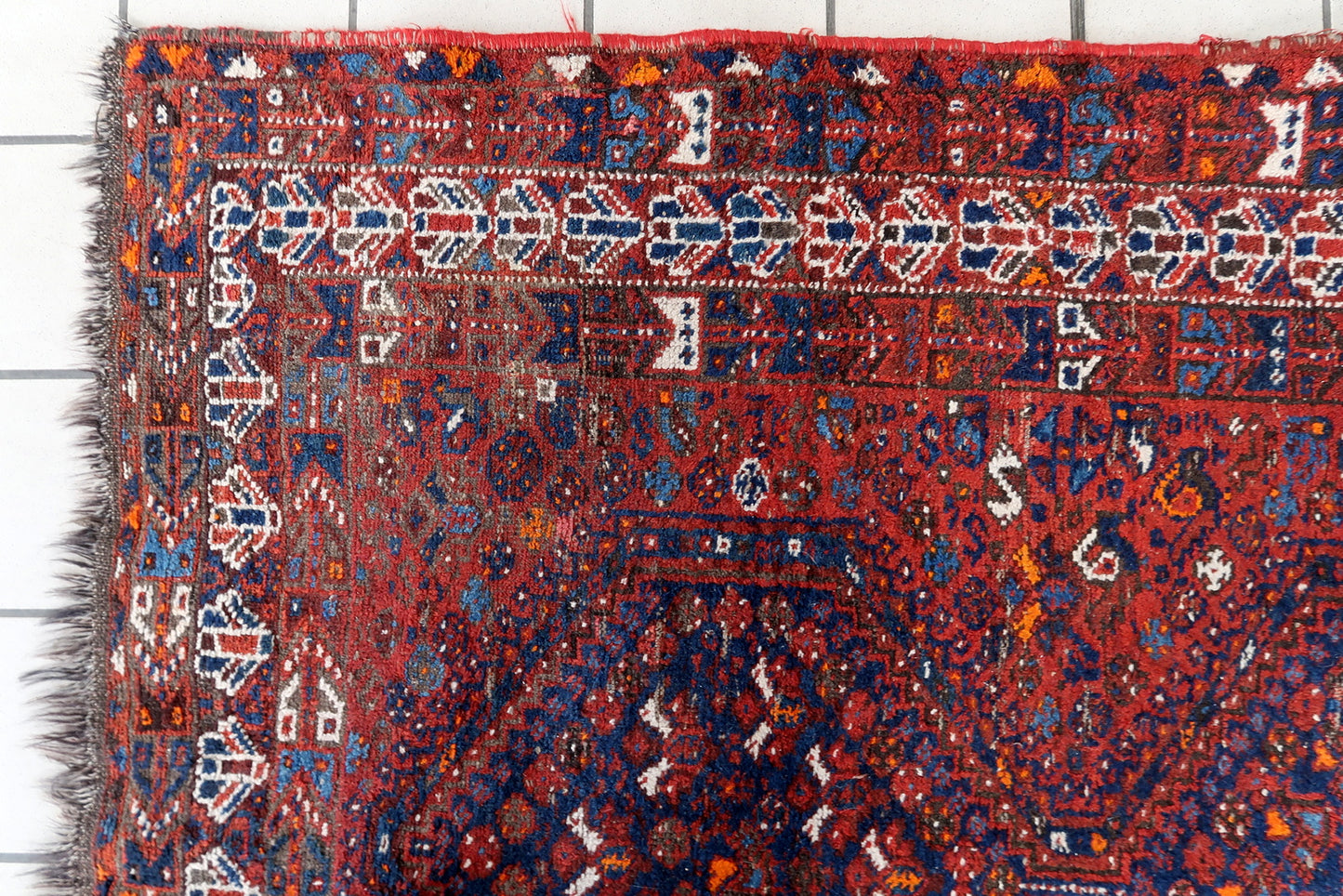 Intricate Geometric Patterns on Antique Persian Rug