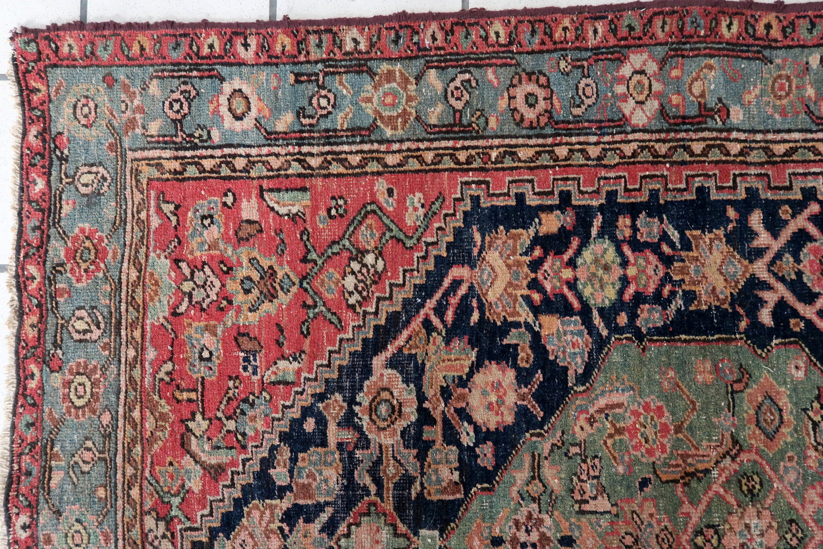 Intricate Floral Patterns on Antique Rug