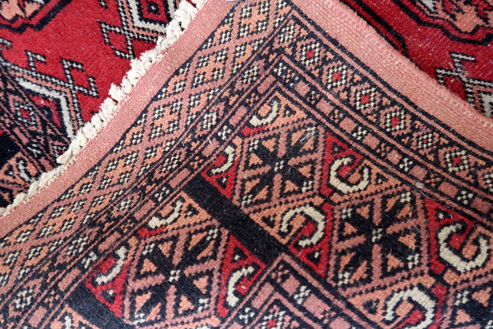 Back side of the Handmade Vintage Uzbek Bukhara Runner, showcasing craftsmanship.