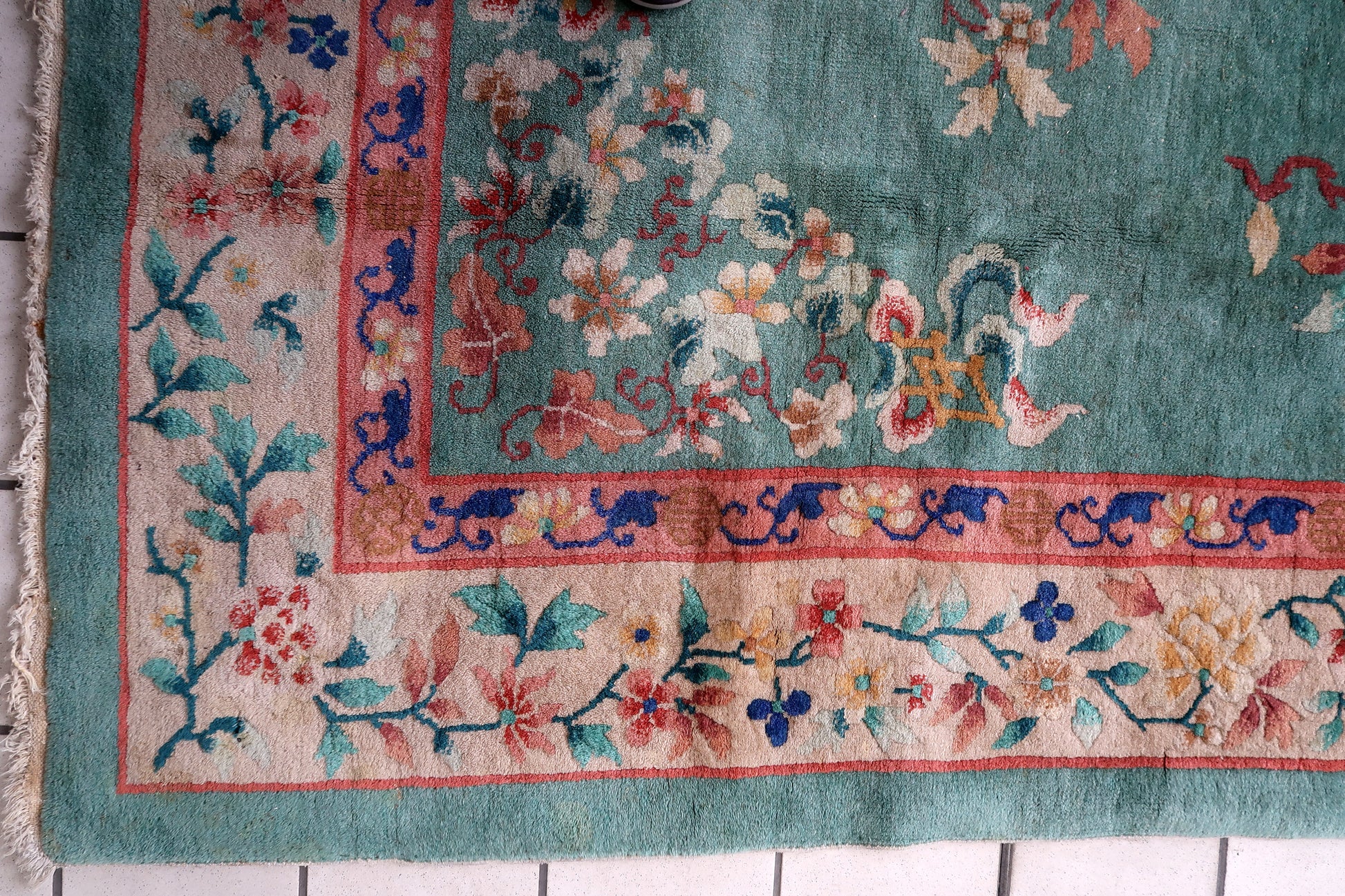 Detailed view of the rug's floral motifs.