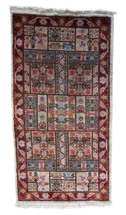 Handmade vintage Tunisian silk rug showcasing geometric shapes and floral motifs from the 1970s
