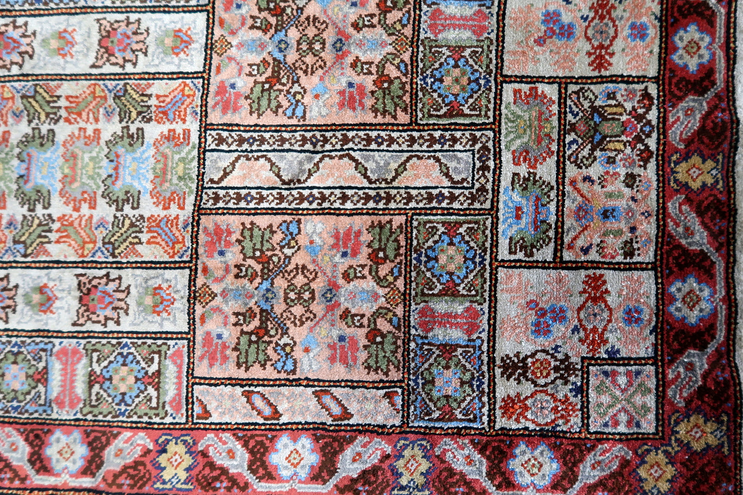 Overhead shot of the Tunisian silk rug displaying its rich, deep red color