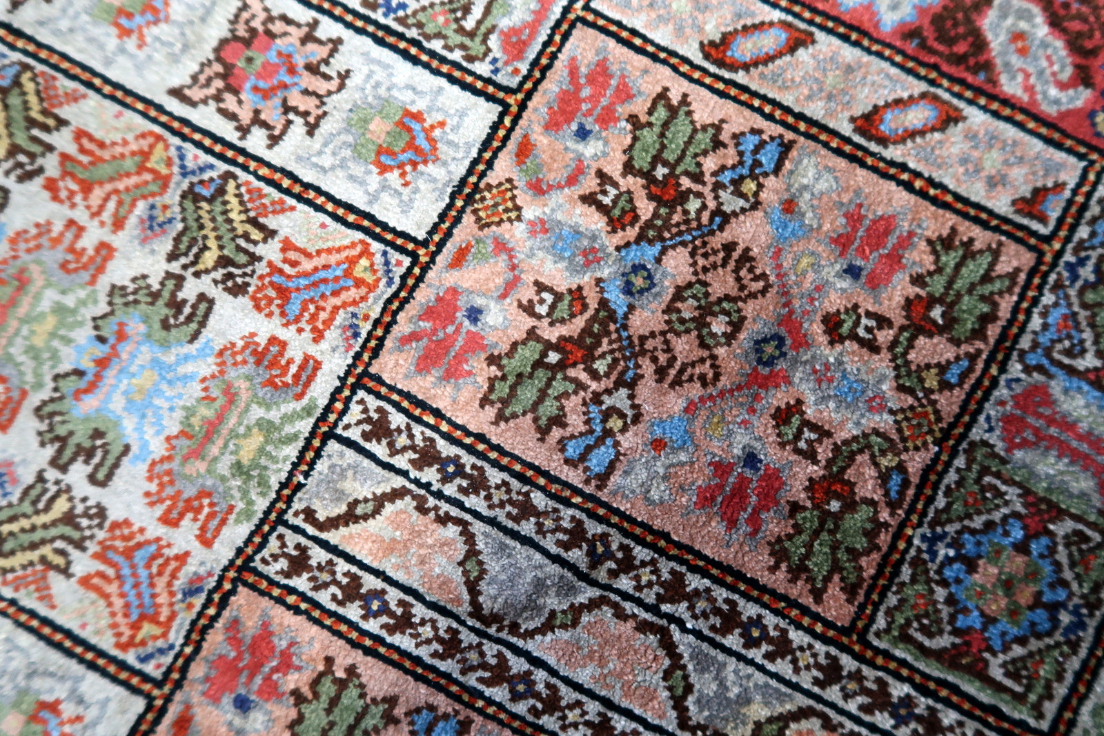 Detailed view of the vintage origins and remarkably good condition of the silk rug
