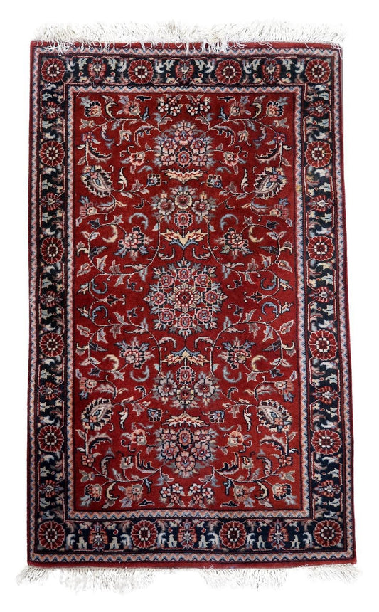 Handmade vintage Persian style Sarouk rug showcasing an elegant arch design and intricate patterns in rich red