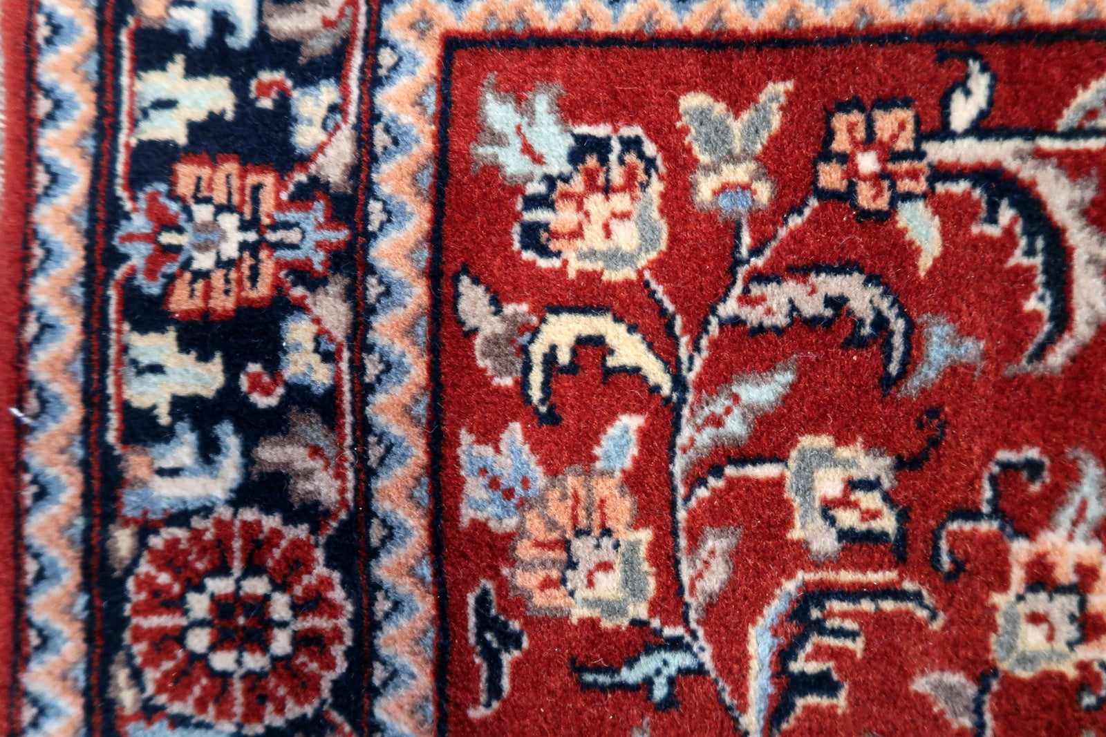 Detailed view of the broader border showcasing complex geometric shapes and floral motifs