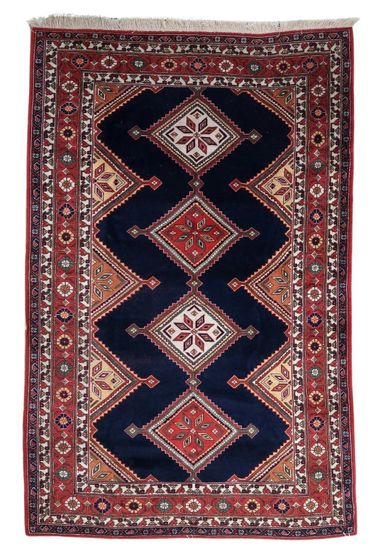 Handmade vintage Persian style Afshar rug showcasing intricate geometric patterns on a deep blue background