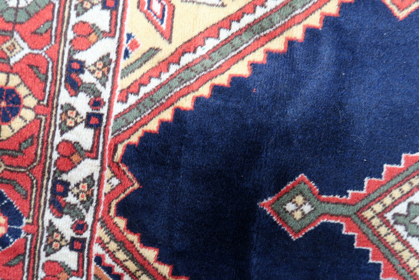 Artistic display of the rug as a focal point in a study, showcasing its timeless beauty and cultural heritage