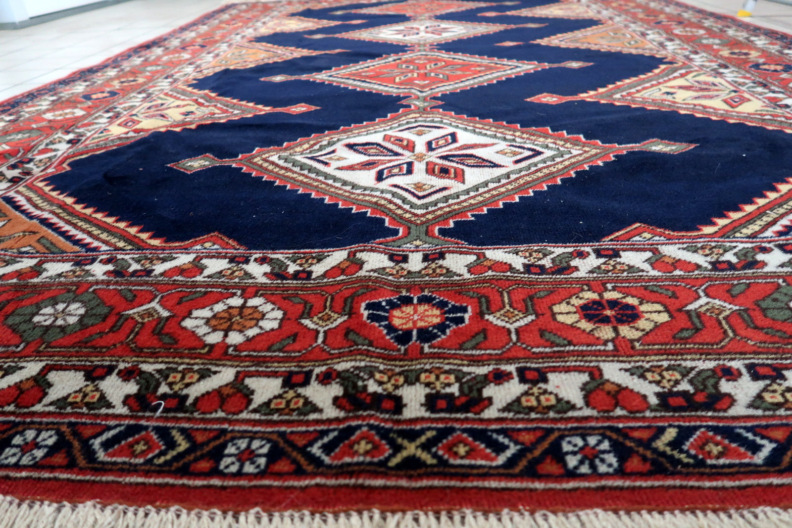 Artistic display of the rug as a focal point in a study, showcasing its timeless beauty and cultural heritage