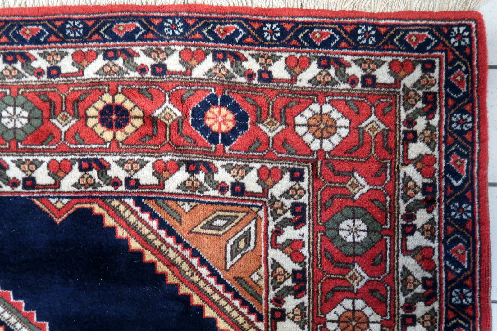 Close-up of the symmetrical geometric designs dominating the central area of the rug
