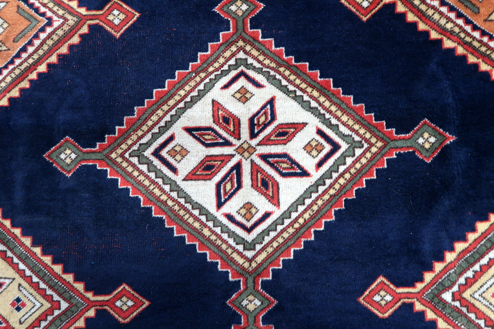 Detailed view of the complex designs in the border, combining floral motifs and geometric shapes
