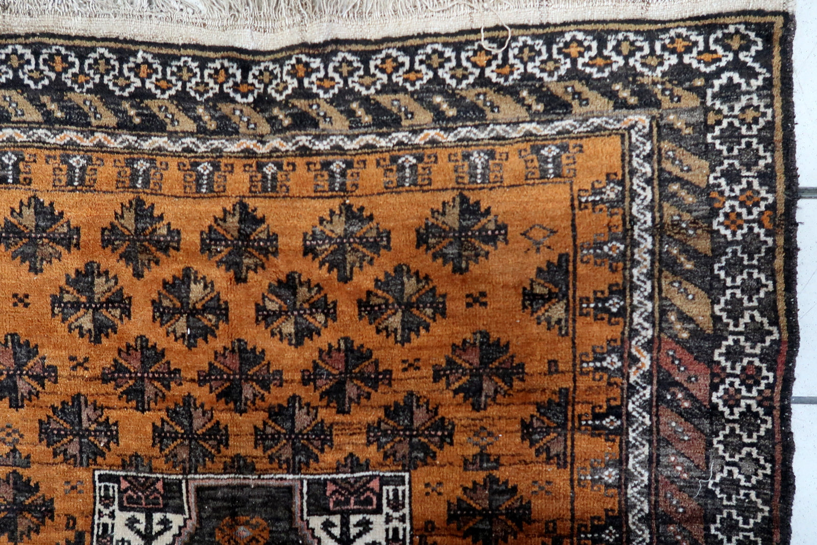 Close-up of the intricate geometric patterns in black and white on the rug's surface
