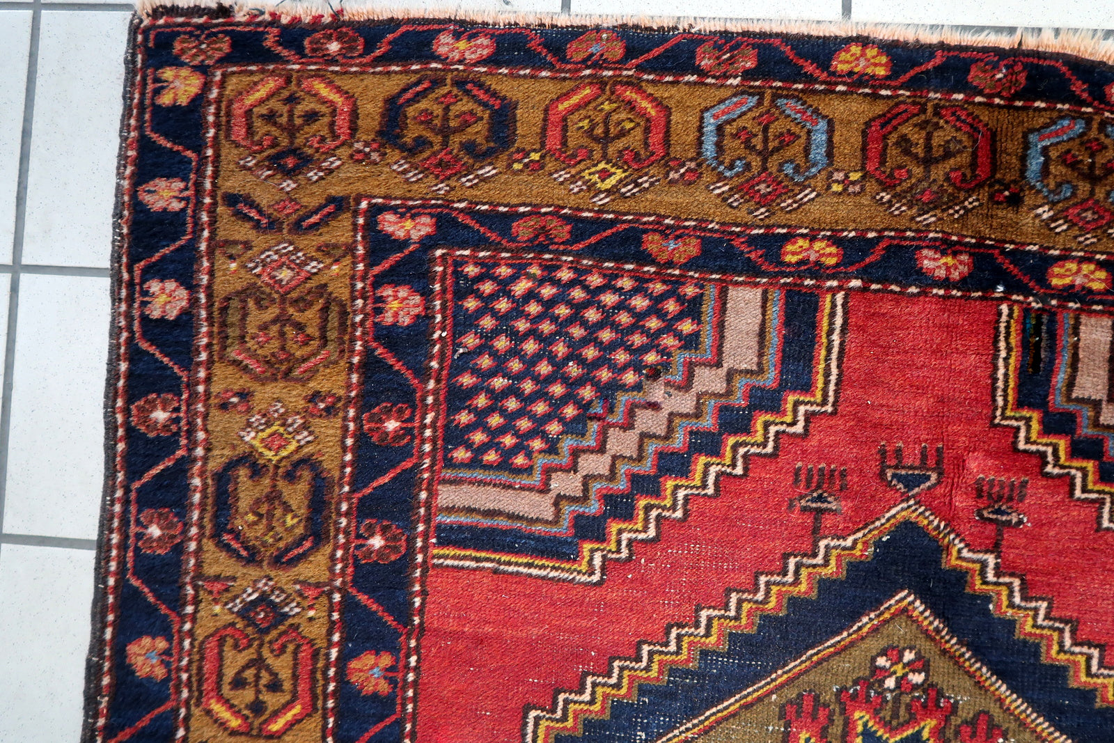 Close-up of the rug's corner, showcasing the intricate craftsmanship and knotting techniques