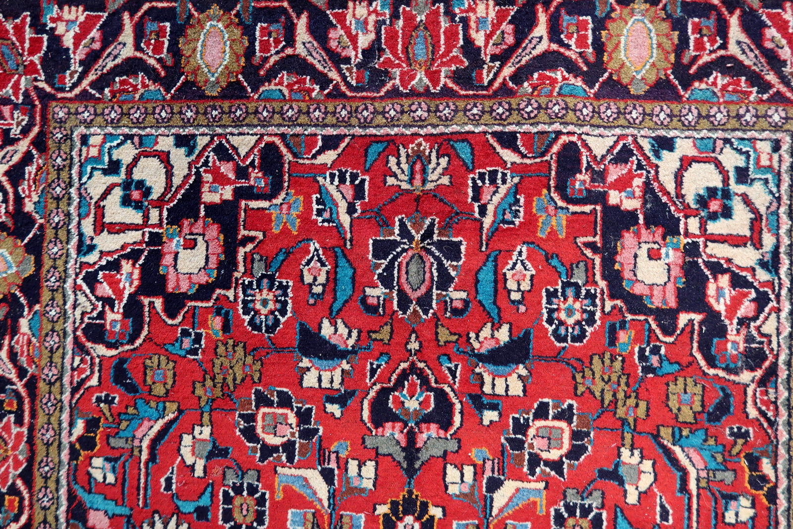 Close-up of the rug's corner, showcasing the intricate craftsmanship and knotting techniques
