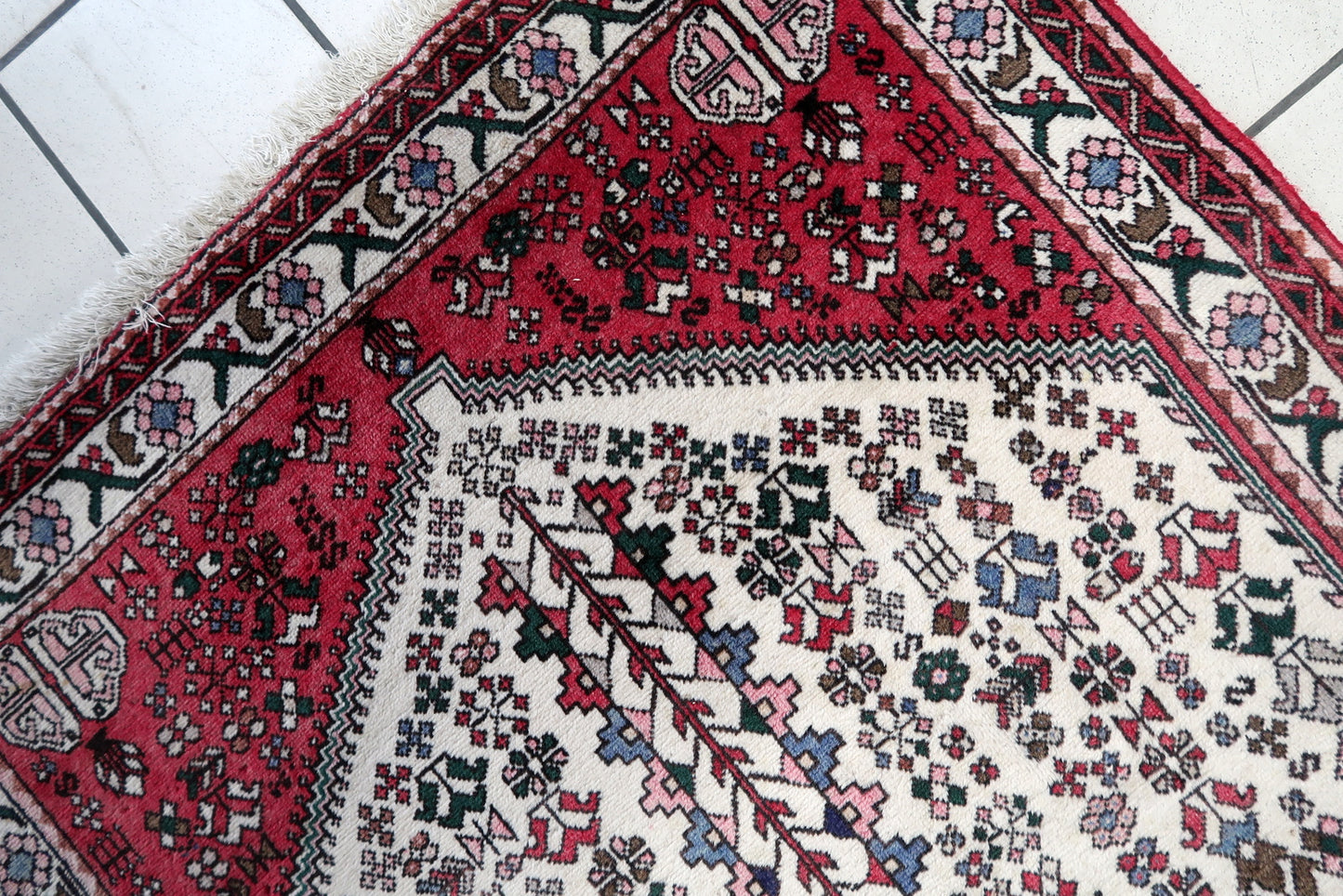 Close-up of the rug's corner, showcasing the intricate craftsmanship and knotting techniques