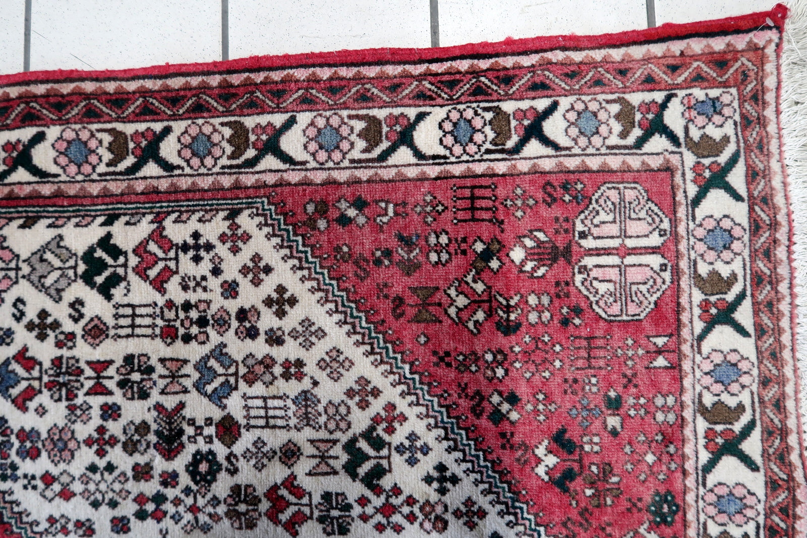 Overhead shot of the Persian Malayer rug displaying its rich color palette and intricate patterns