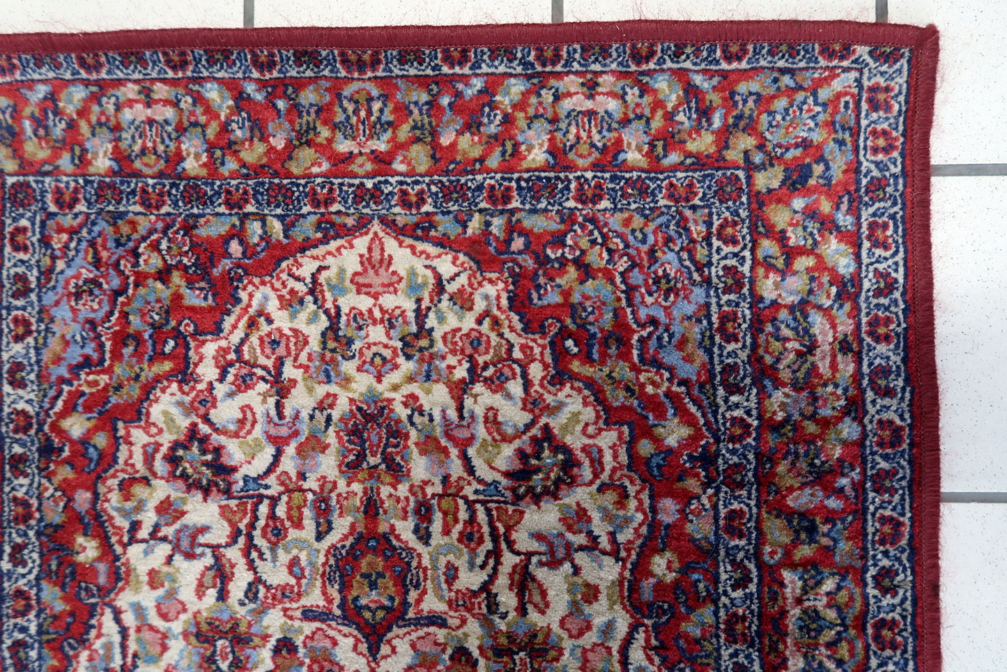 Close-up of the central part of the rug displaying intricate geometric motifs