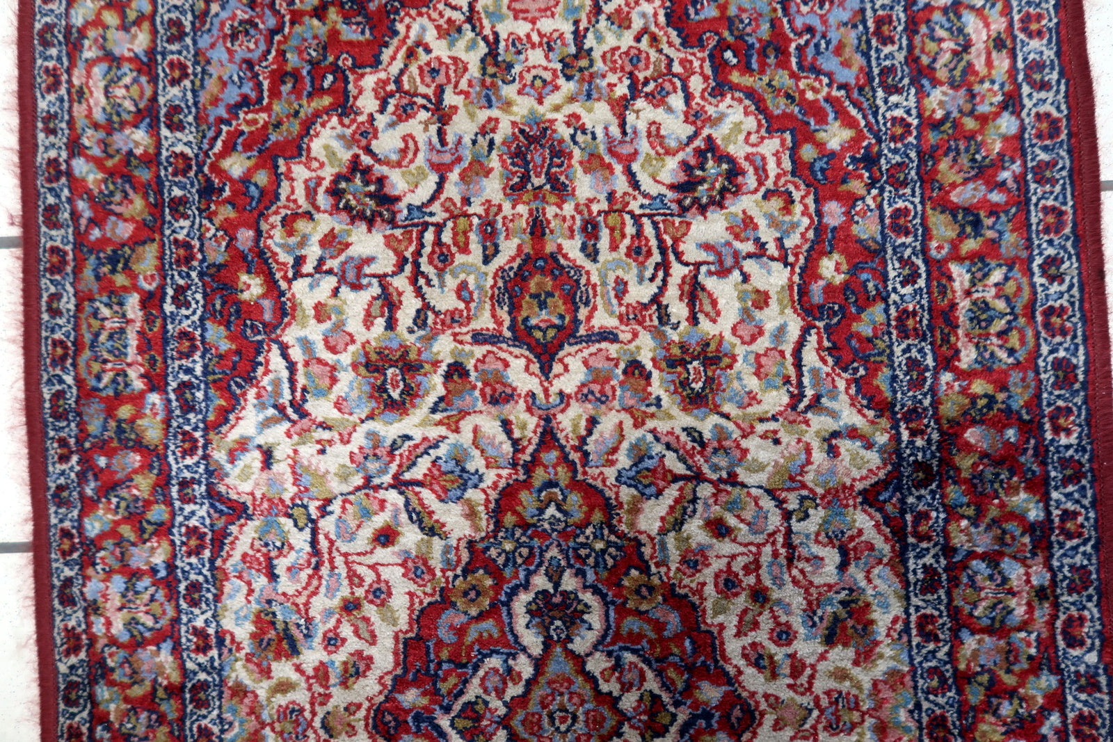 Overhead shot of the Indian rug displaying its rich color palette and detailed patterns