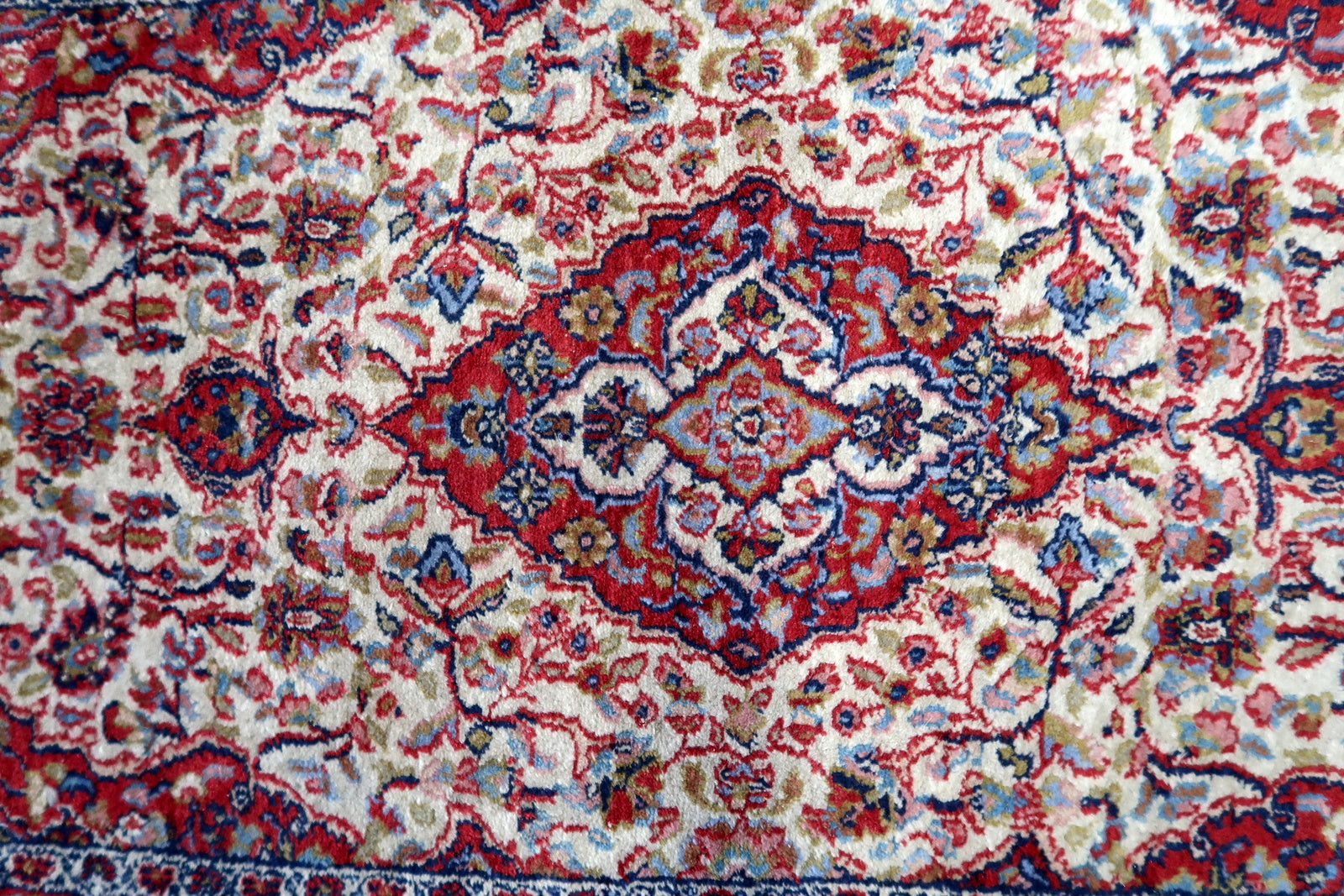 Close-up of the intricate floral elements woven into the rug's design