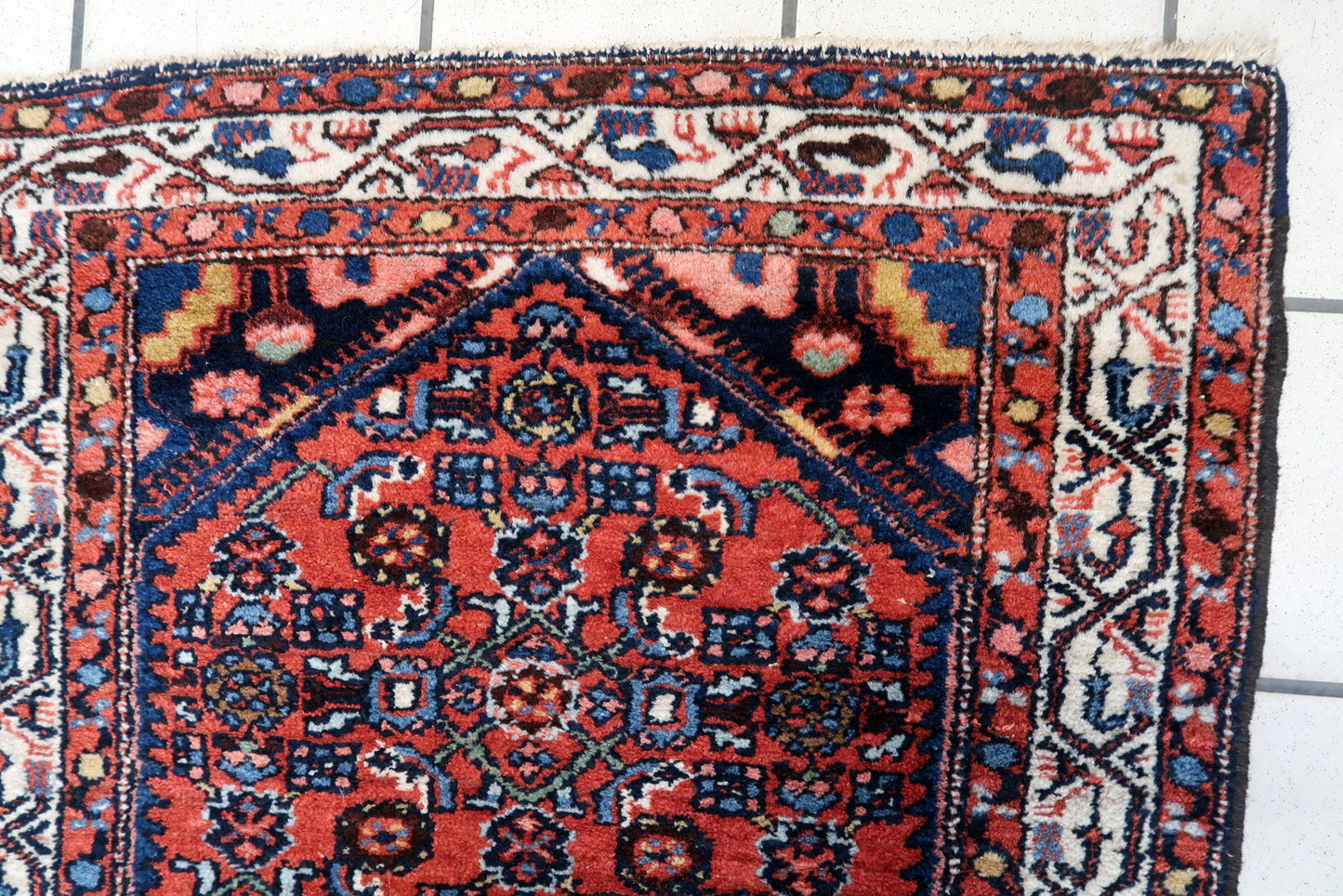 Close-up of the central field of the rug displaying elaborate geometric designs
