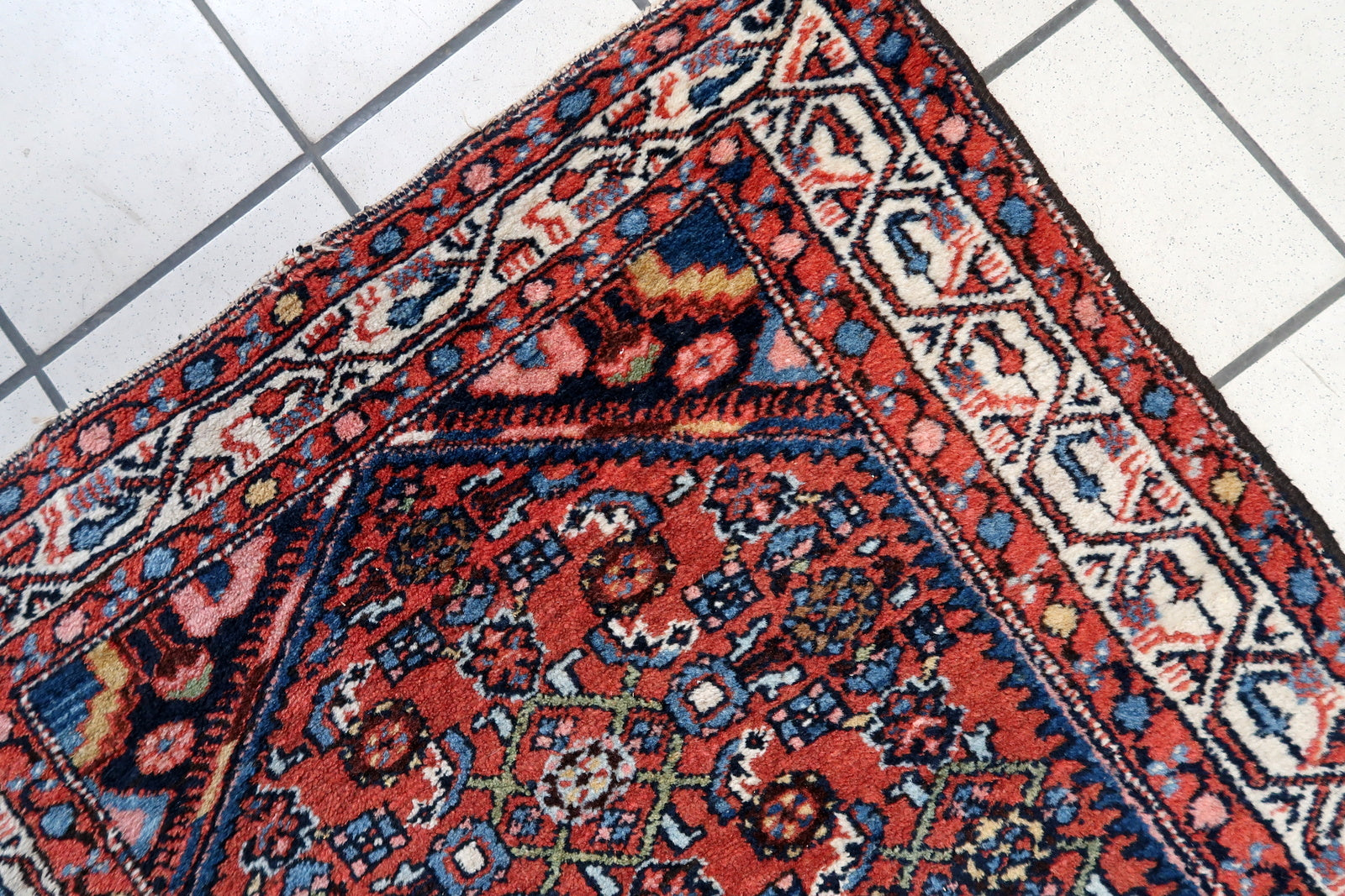 Front view of the handmade Persian rug adding warmth to a living room