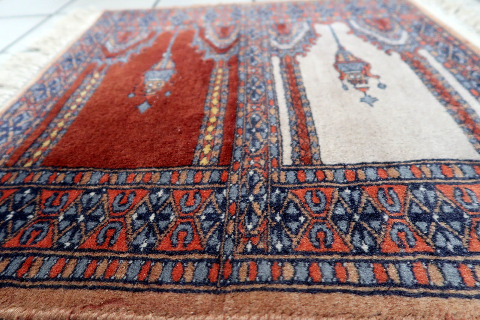 Artistic display of the rug in a prayer area, adding spirituality and tradition to the space