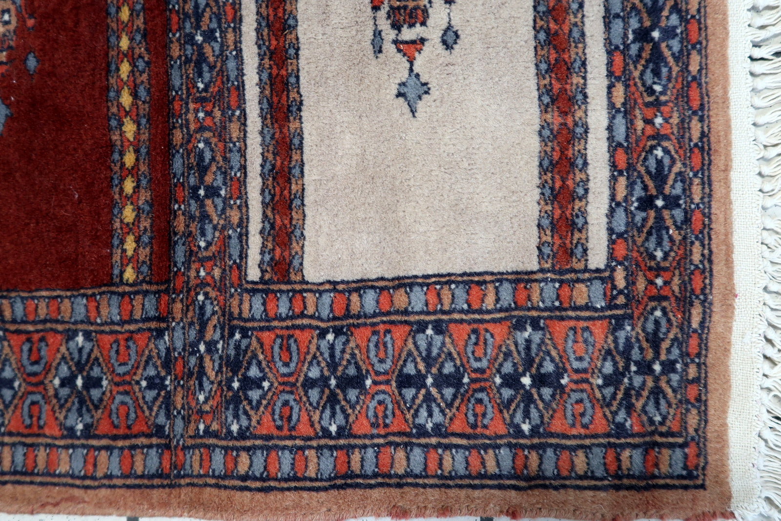 Close-up of the central design featuring hanging lantern-like figures and intricate geometric patterns