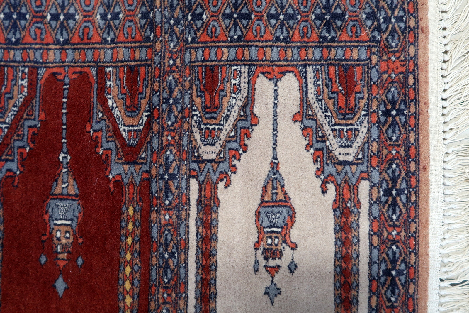 Overhead shot of the rug displaying its symmetrical patterns and faded colors