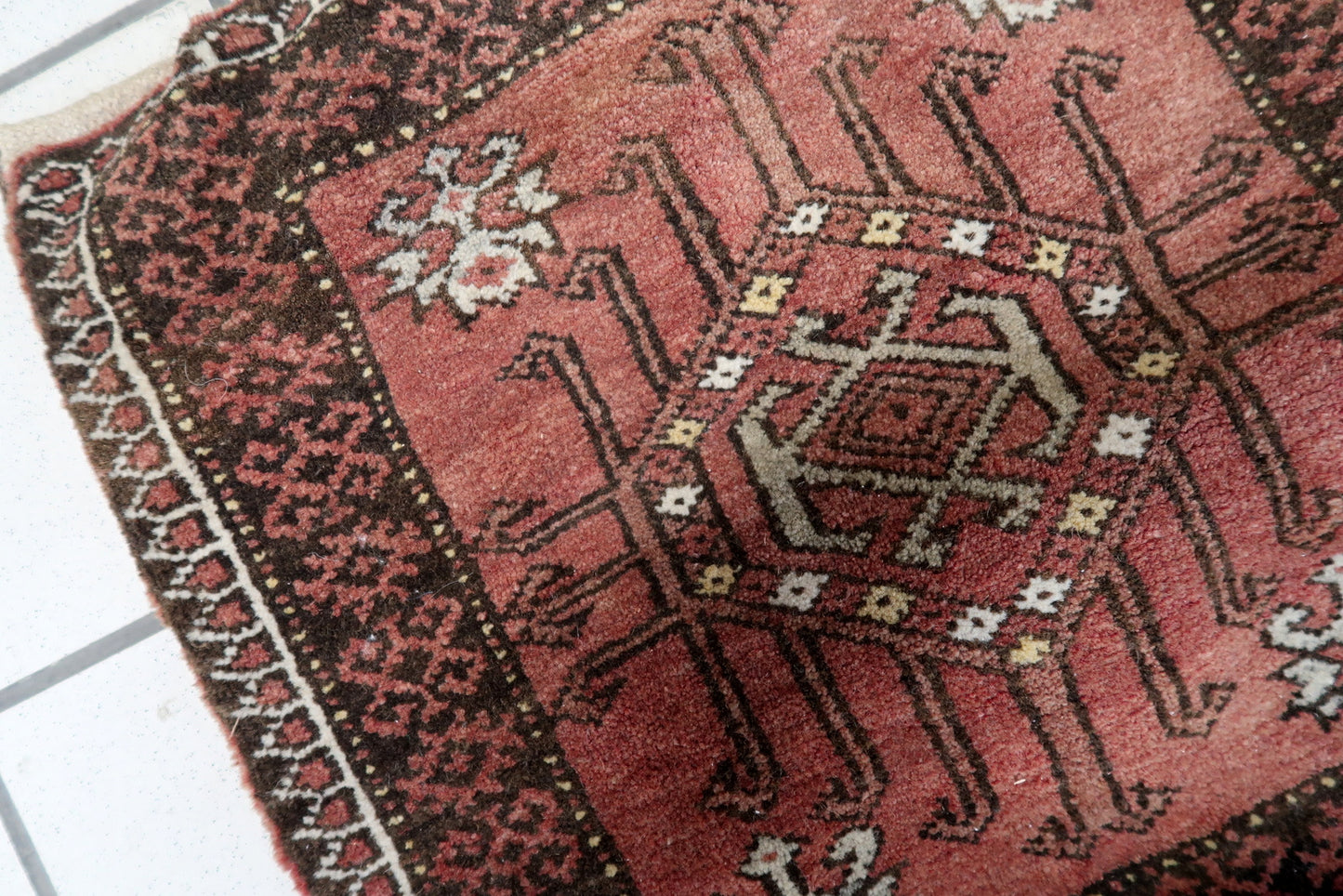 Close-up of the geometric motifs woven into the fabric of the saddle bag