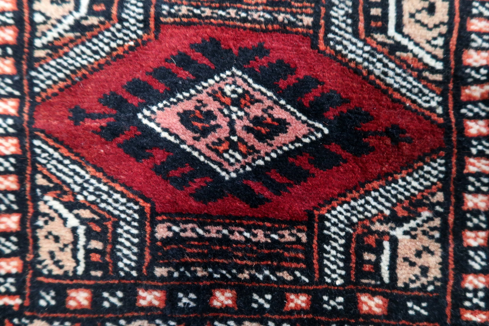 Overhead shot of the mat rug displaying its symmetrical patterns and faded colors