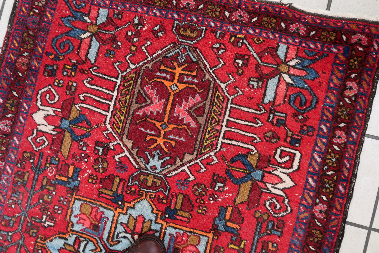 Intricate Geometric and Floral Designs Adorning Surface of Handmade Wool Rug - 1920s