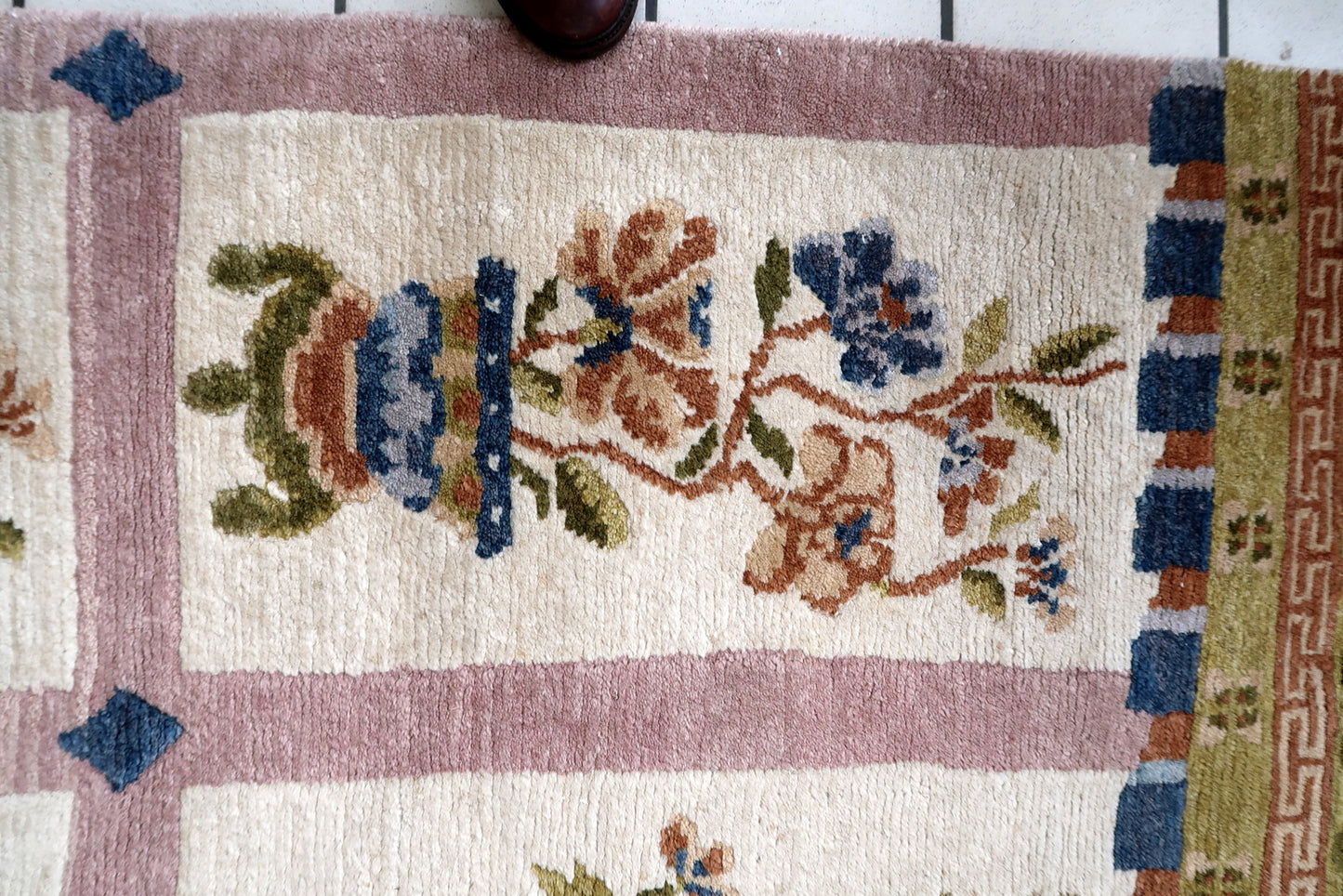 Base Color of Rug in Off-White or Beige, with Decorative Elements in Blues, Reds, Greens, and Browns - 1970s
