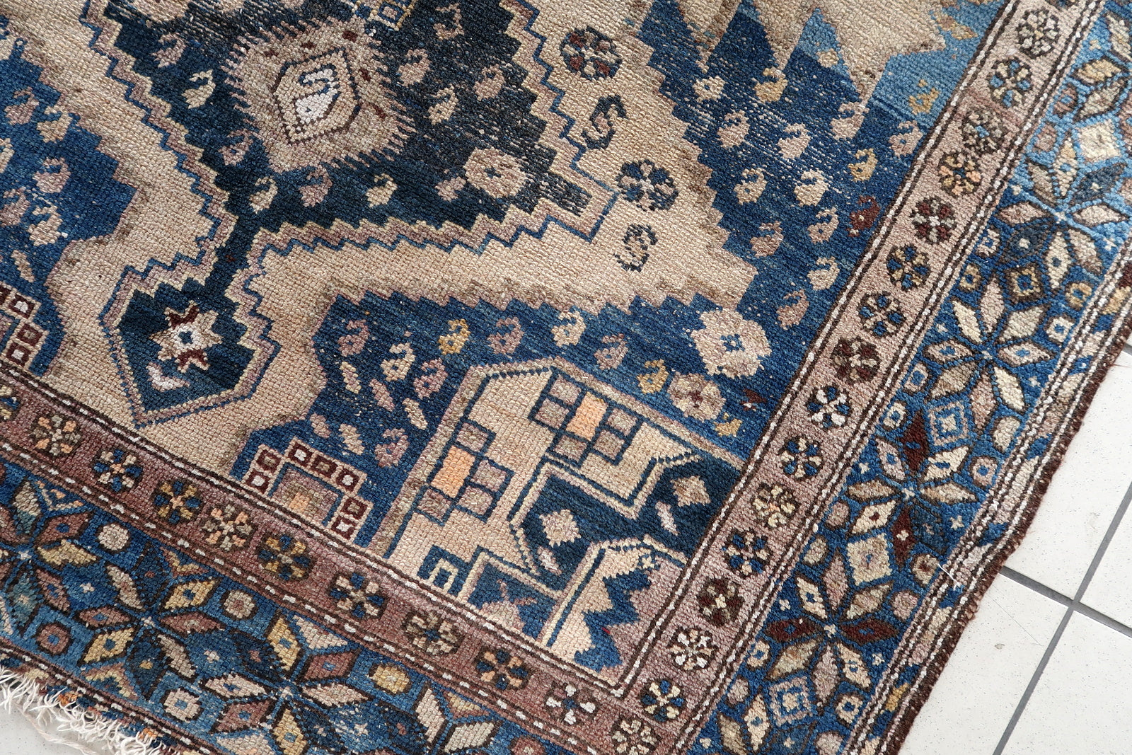 Close-up of cozy living room setting with Handmade Antique Caucasian Shirvan Rug - Detailed view showing the rug enhancing the warmth of a cozy living room.